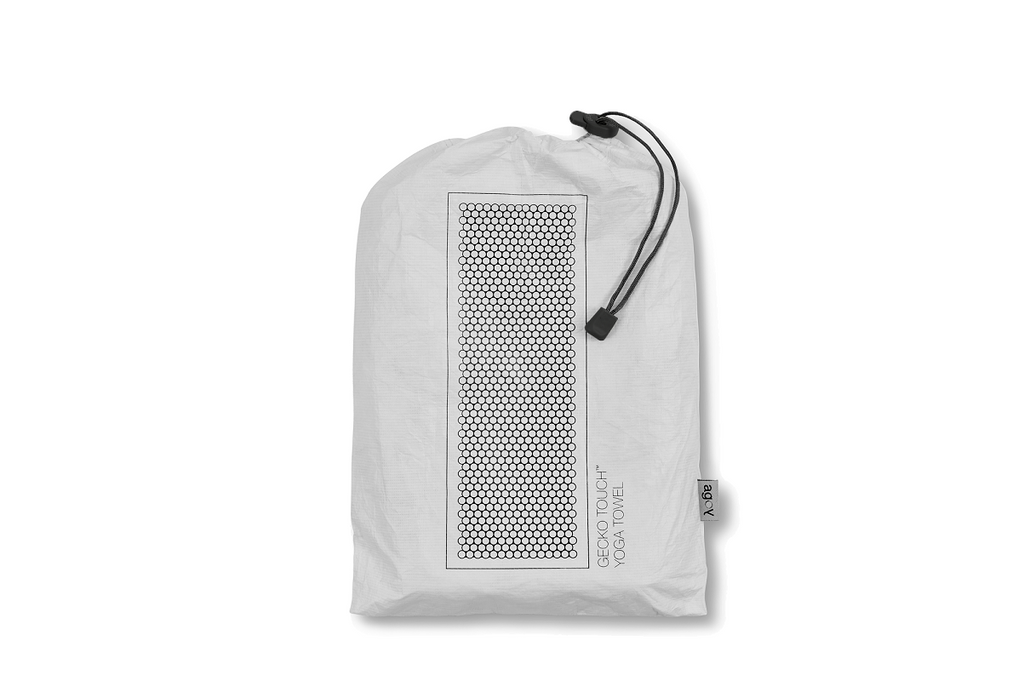 The GECKO TOUCH – Nightfall yoga towel features a simple yet elegant symmetrical circular pattern made of tactile silicone, offering a unique wet/dry grip. It comes with a sleek black graphite base with contrasting colored stitching and is made using an eco-friendly, dye-free process.