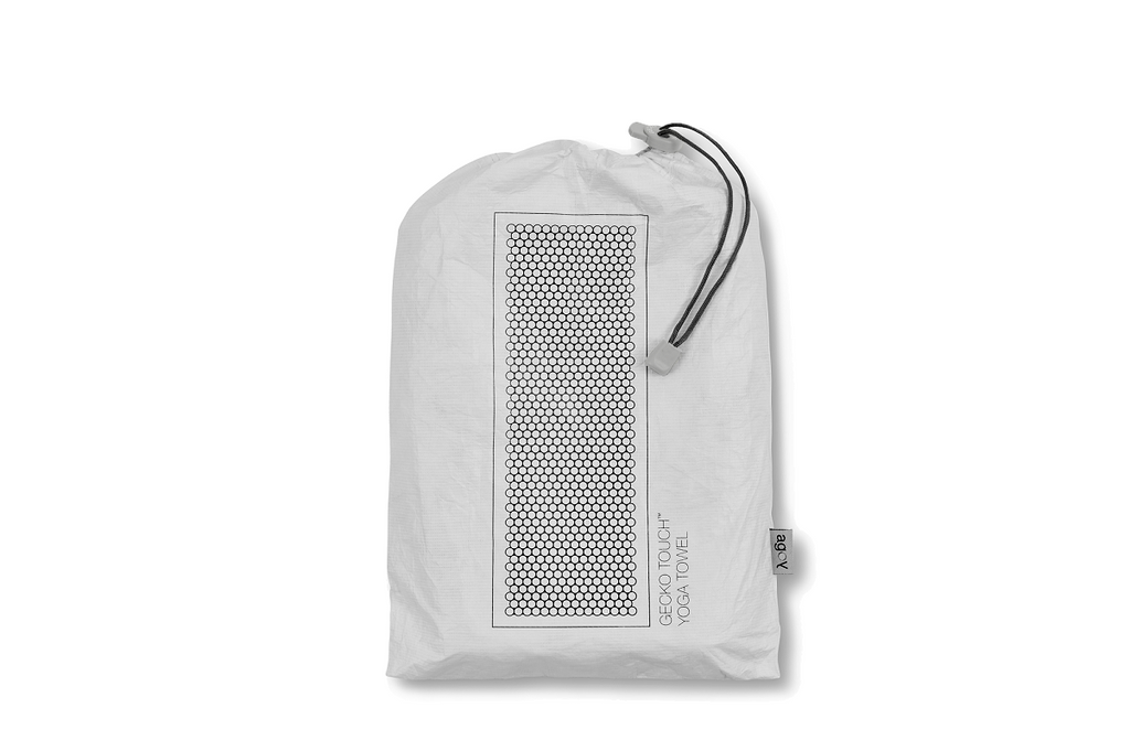 The GECKO TOUCH – Nightfall yoga towel features a simple yet elegant symmetrical circular pattern made of tactile silicone, offering a unique wet/dry grip. It comes with a sleek black graphite base with contrasting colored stitching and is made using an eco-friendly, dye-free process.