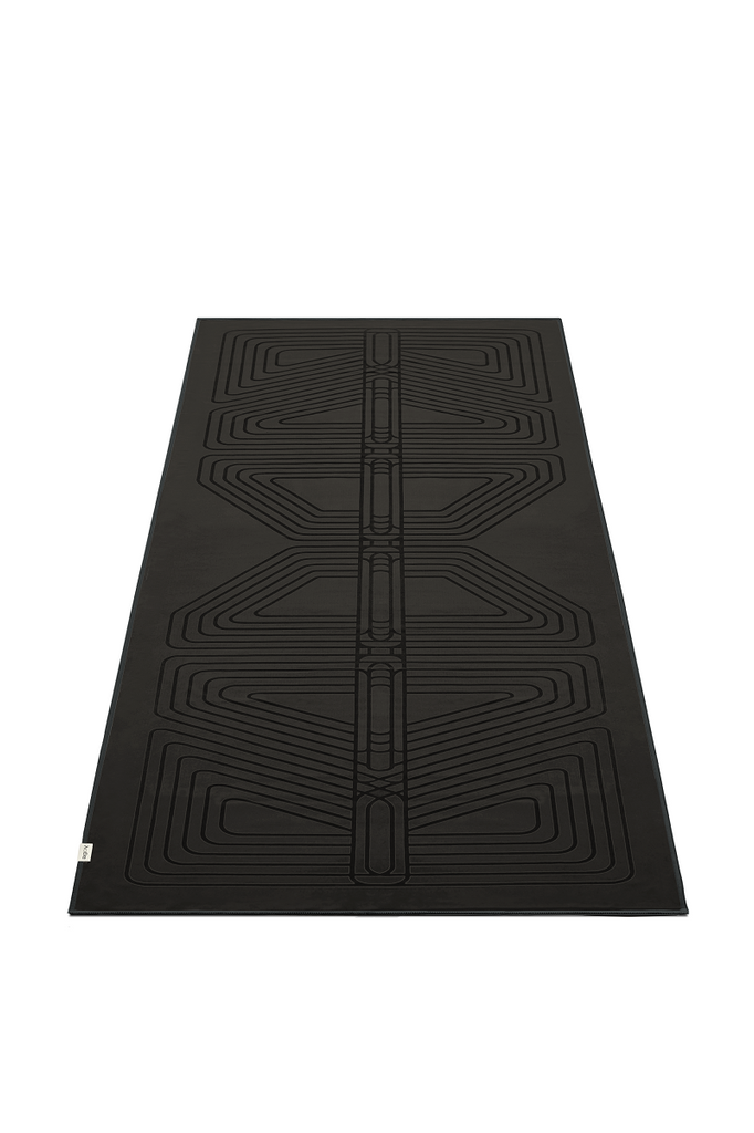 The GECKO WARRIOR – Nightfall yoga towel features a unique wet/dry grip Focus Alinement™ pattern made of tactile silicone, inspired by but not directly taken from ancient warrior cultures. It comes with a sleek black graphite base with contrasting colored stitching and is made using an eco-friendly, dye-free process.