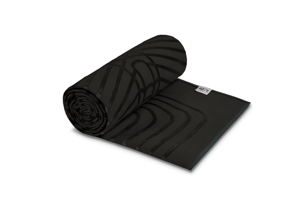 The GECKO WARRIOR – Nightfall yoga towel features a unique wet/dry grip Focus Alinement™ pattern made of tactile silicone, inspired by but not directly taken from ancient warrior cultures. It comes with a sleek black graphite base with contrasting colored stitching and is made using an eco-friendly, dye-free process.