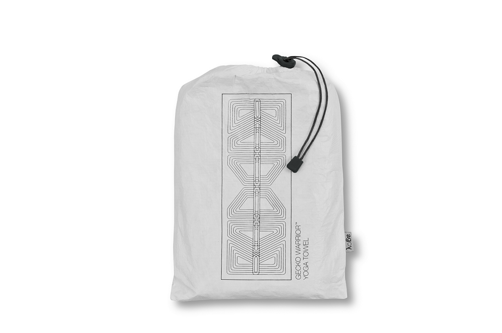 The GECKO WARRIOR – Nightfall yoga towel features a unique wet/dry grip Focus Alinement™ pattern made of tactile silicone, inspired by but not directly taken from ancient warrior cultures. It comes with a sleek black graphite base with contrasting colored stitching and is made using an eco-friendly, dye-free process.