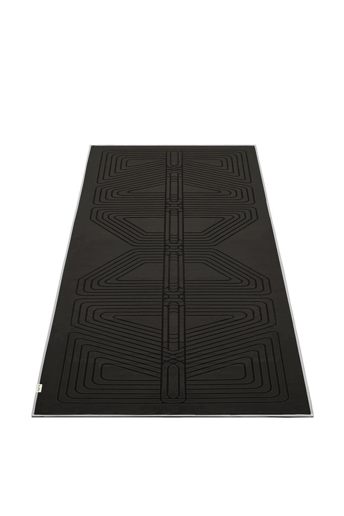 The GECKO WARRIOR – Nightfall yoga towel features a unique wet/dry grip Focus Alinement™ pattern made of tactile silicone, inspired by but not directly taken from ancient warrior cultures. It comes with a sleek black graphite base with contrasting colored stitching and is made using an eco-friendly, dye-free process.