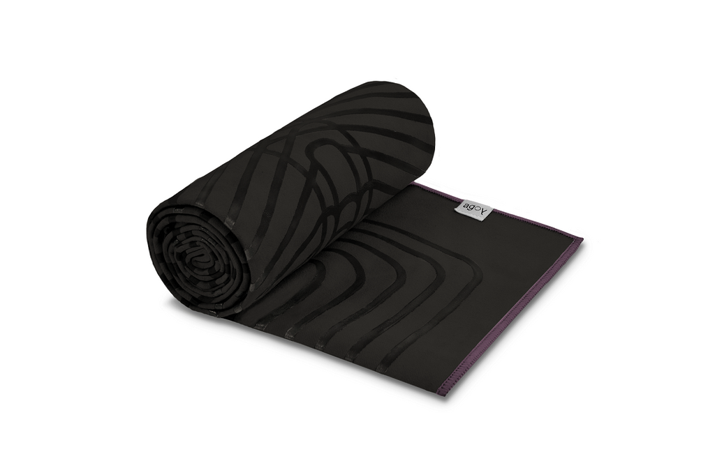 The GECKO WARRIOR – Nightfall yoga towel features a unique wet/dry grip Focus Alinement™ pattern made of tactile silicone, inspired by but not directly taken from ancient warrior cultures. It comes with a sleek black graphite base with contrasting colored stitching and is made using an eco-friendly, dye-free process.