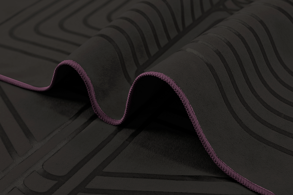 The GECKO WARRIOR – Nightfall yoga towel features a unique wet/dry grip Focus Alinement™ pattern made of tactile silicone, inspired by but not directly taken from ancient warrior cultures. It comes with a sleek black graphite base with contrasting colored stitching and is made using an eco-friendly, dye-free process.