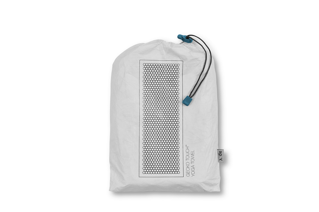 The GECKO TOUCH – Nightfall yoga towel features a simple yet elegant symmetrical circular pattern made of tactile silicone, offering a unique wet/dry grip. It comes with a sleek black graphite base with contrasting colored stitching and is made using an eco-friendly, dye-free process.