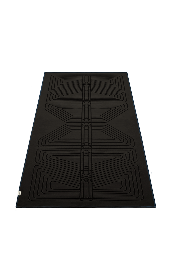 The GECKO WARRIOR – Nightfall yoga towel features a unique wet/dry grip Focus Alinement™ pattern made of tactile silicone, inspired by but not directly taken from ancient warrior cultures. It comes with a sleek black graphite base with contrasting colored stitching and is made using an eco-friendly, dye-free process.
