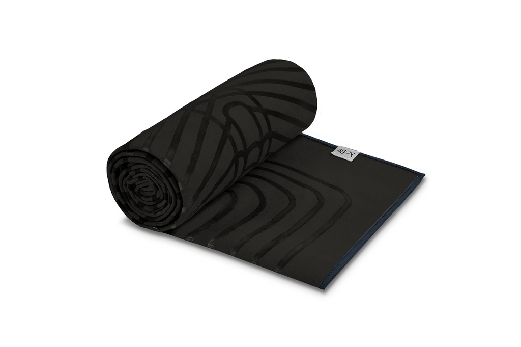 The GECKO WARRIOR – Nightfall yoga towel features a unique wet/dry grip Focus Alinement™ pattern made of tactile silicone, inspired by but not directly taken from ancient warrior cultures. It comes with a sleek black graphite base with contrasting colored stitching and is made using an eco-friendly, dye-free process.